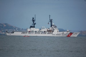 The USCGC Boutwell being escorted by a Coast Guart patrol boat.