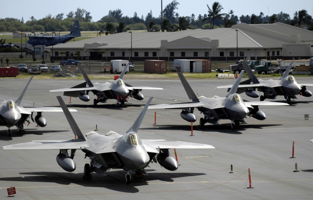 F-22 Raptors sit on the flight line at Hickam Air Force Base, Hawaii Feb. 12.  The fighters and more than 250 Airmen from the 27th Fighter Squadron at Langley Air Force Base, Va., are bound for Kadena Air Base, Japan.  This is the Raptor's first overseas operational deployment. (U.S. Air Force photo/ Tech. Sgt. Shane A. Cuomo)