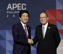 Japanese Prime Minister Shinzo Abe, left, is welcomed to the opening plenary session by President Benigno Aquino III at the Asia-Pacific Economic Cooperation (APEC) Summit in Manila, Philippines, (Mast Irham/Pool Photo via AP)