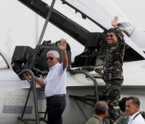 Philippine Defense Secretary Voltaire Gazmin, left, and Armed Forces Chief Gen. Hernando Iriberri wave from a newly-acquired FA-50PH fighter jet. (Source: AP)