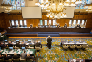 Hearing on Jurisdiction and Admissibility in session, July 2015, Peace Palace, The Hague. Philippine Secretary for Foreign Affairs, Albert F. Del Rosario (center) addressing the Arbitral Tribunal. China’s table (right) is empty as they have declined to participate in the proceedings. PHOTO FROM THE PERMANENT COURT OF ARBITRATION