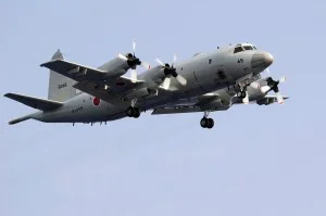 A Japan Maritime Self-Defense Force (JMSDF) P-3C Orion flies above the aircraft carrier USS Kitty Hawk (CV 63) during a 19-ship group photo exercise. File:US Navy
